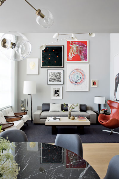 409550-In_the_dining_and_living_areas_of_a_duplex_loft_chandeliers_by_Lindsey_Adelman_and_David_Weeks_accent_the_art_collection_which